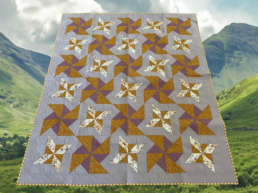 Lovely Pinwheels quilt with flannel backing (66” x 72”)